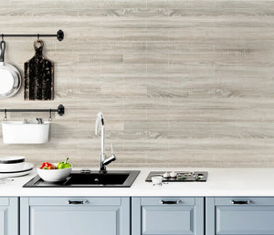 Kitchen with light peel and stick wood look backsplash and white countertop